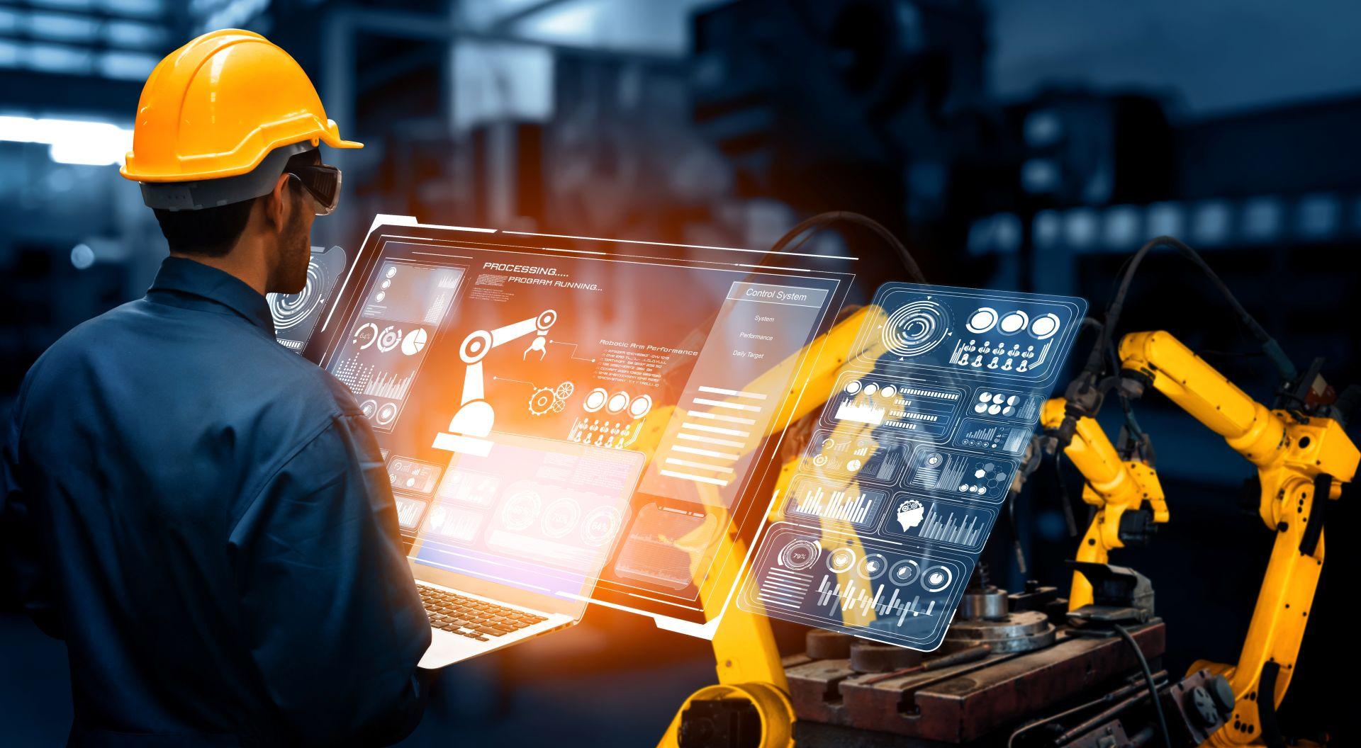 Techniker bedient Laptop mit Maschinendaten zur Produktionsanalyse